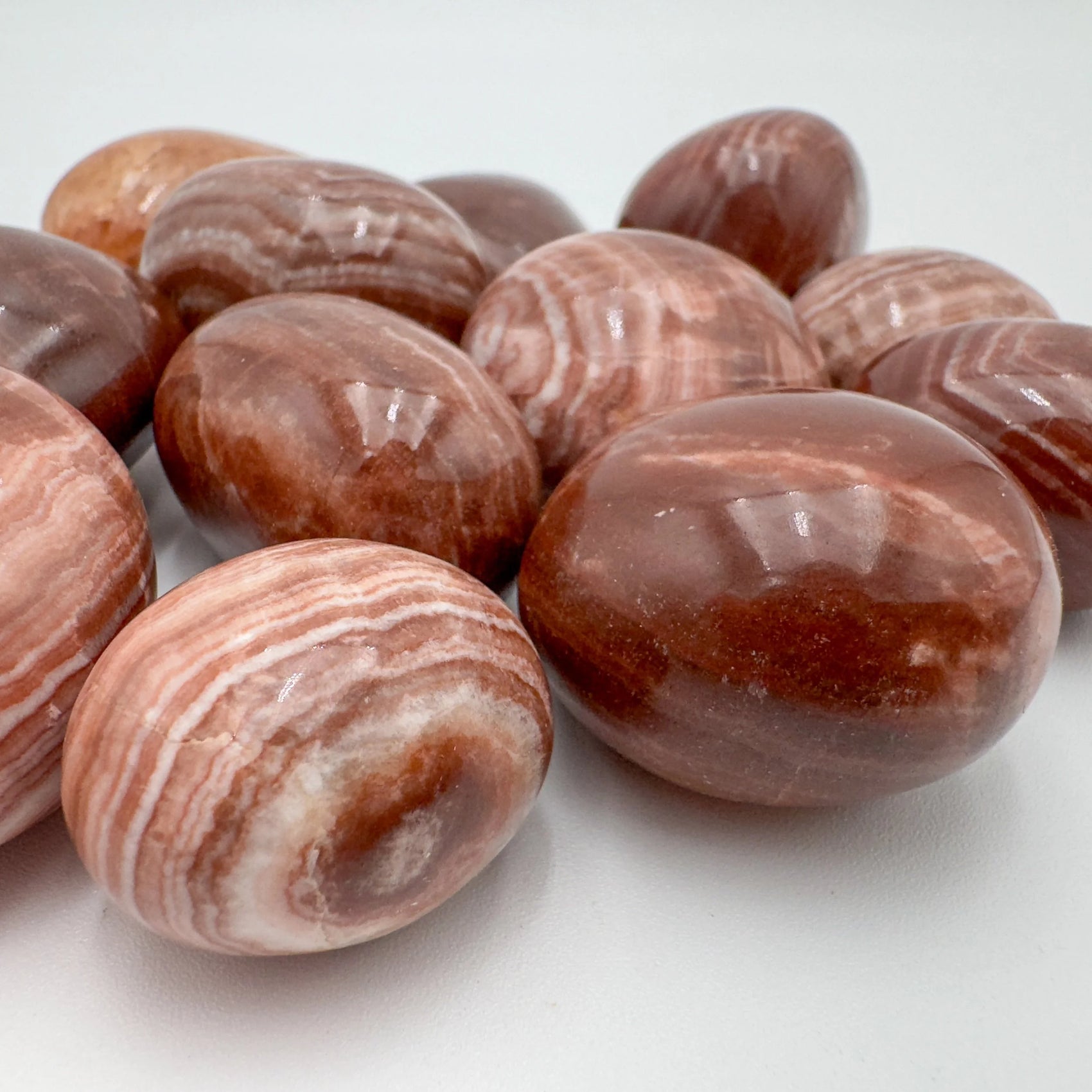 Up-close view of Red Aragonite tumbled stone, often kept for Energy and Confidence.