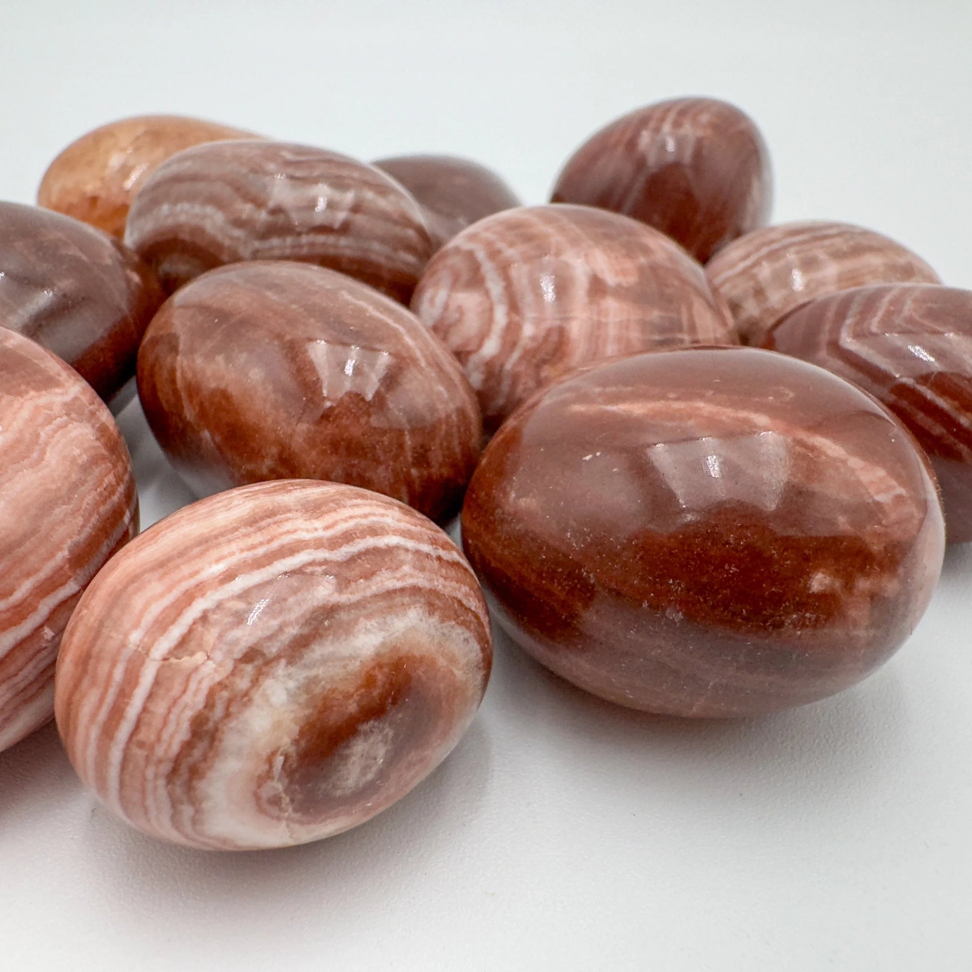 Up-close view of Red Aragonite tumbled stone, often kept for Energy and Confidence.