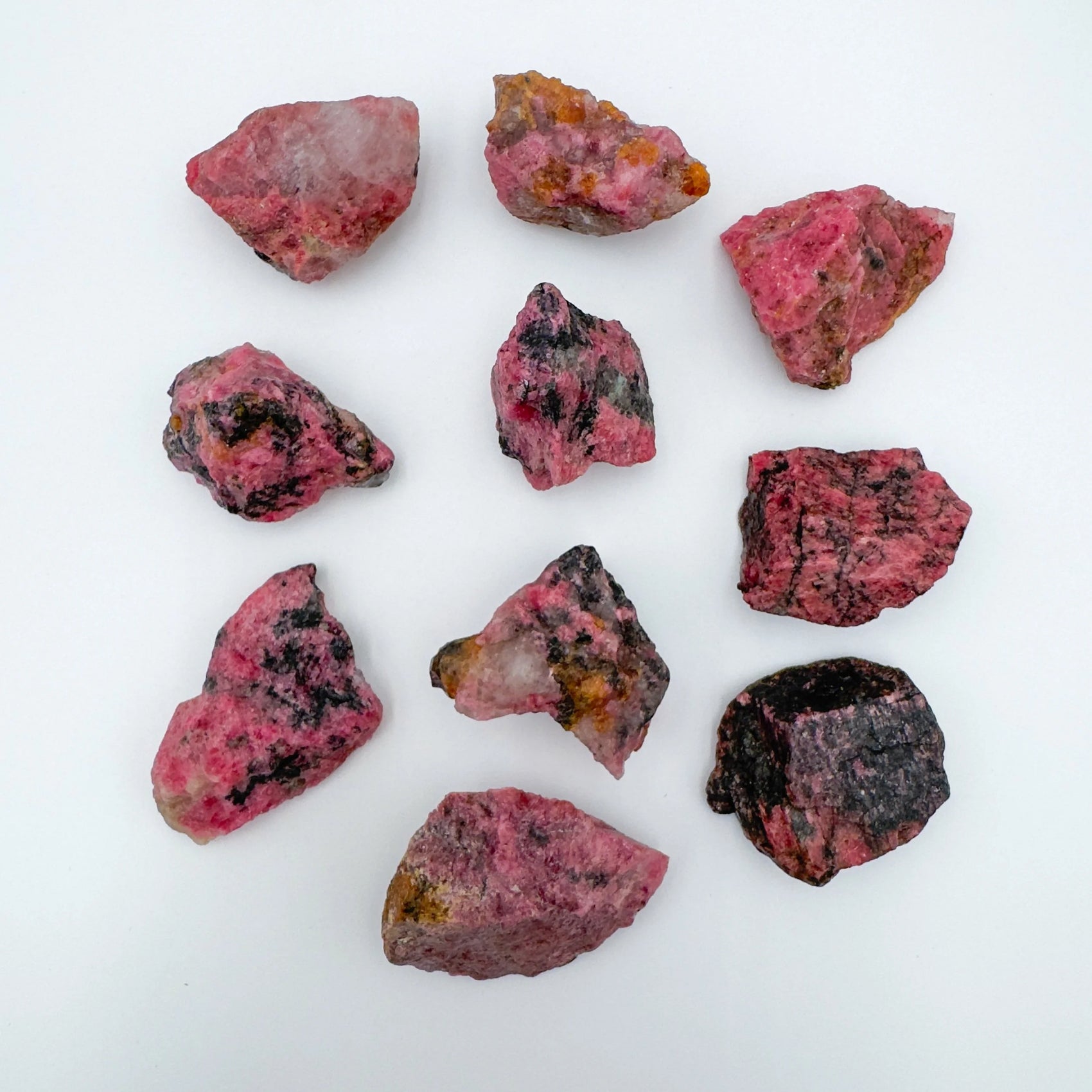 Close-up of Rhodonite raw stone from Zimbabwe, soothing wellness stone for Emotional Healing