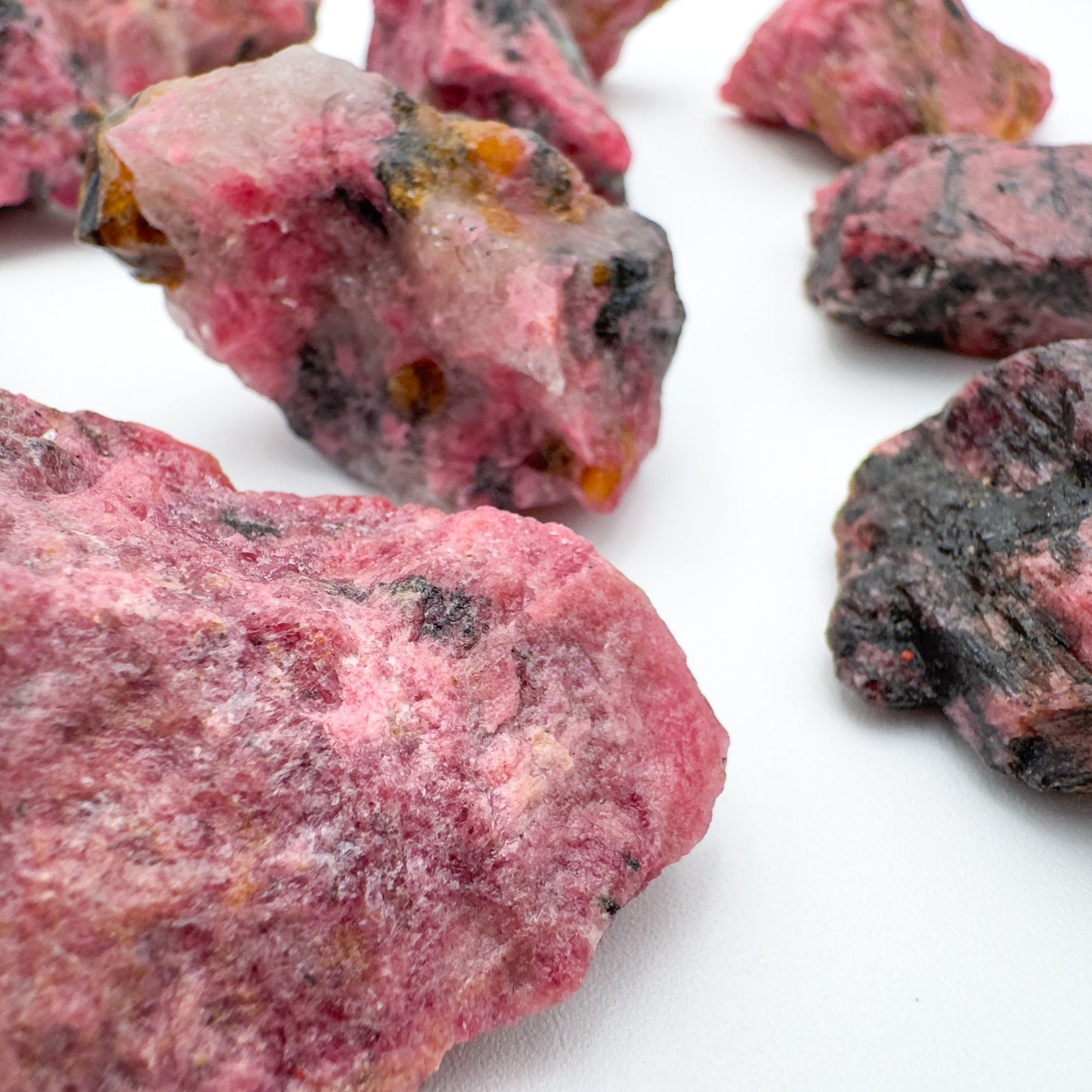 Plan view of Rhodonite raw stone, Zimbabwe-sourced, often worked with for Emotional Healing and Love.
