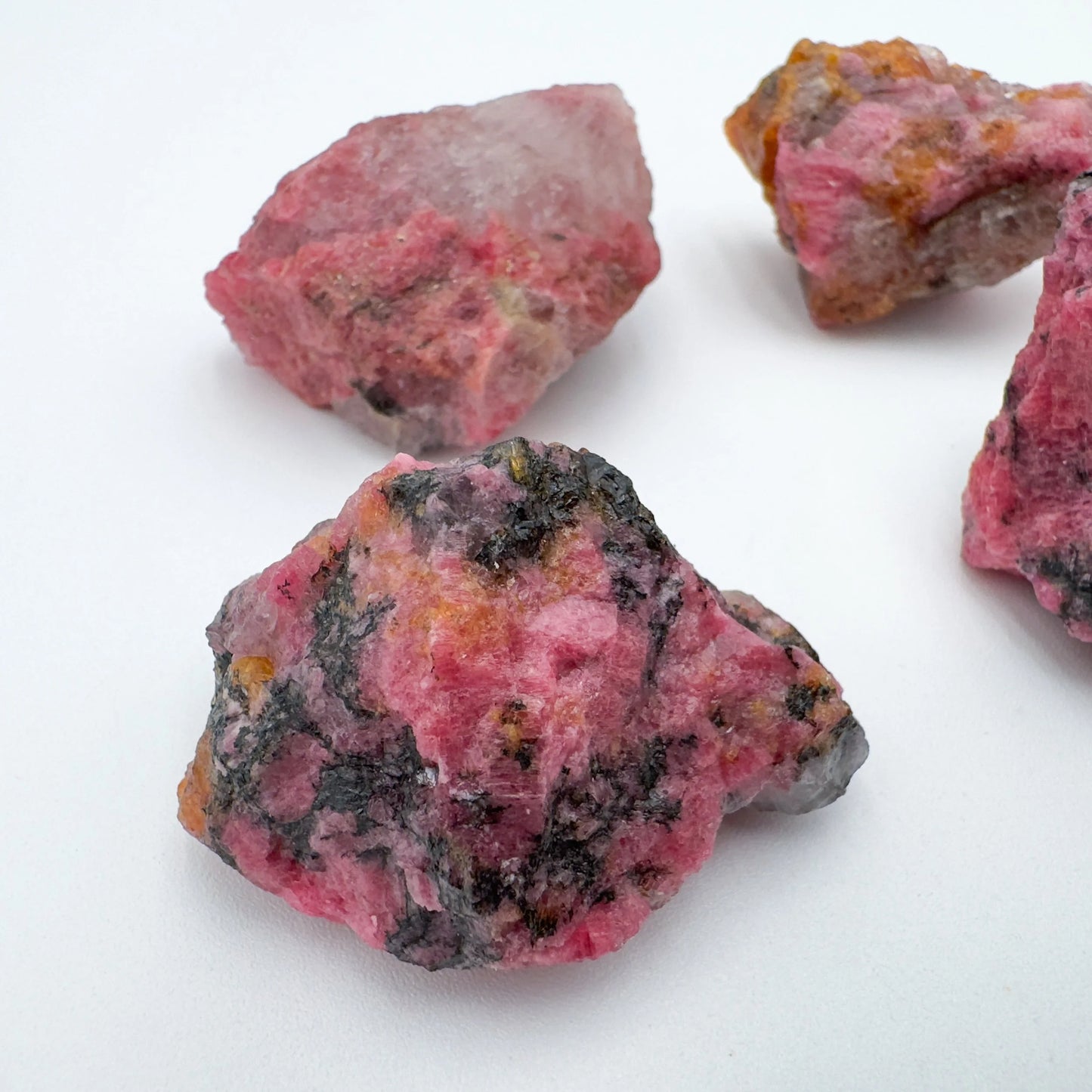 Size comparison with a Rhodonite raw stone, from Zimbabwe.