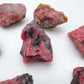 Quiet study of Rhodonite raw crystal, from Masvingo, Zimbabwe, in the warmth of daylight.