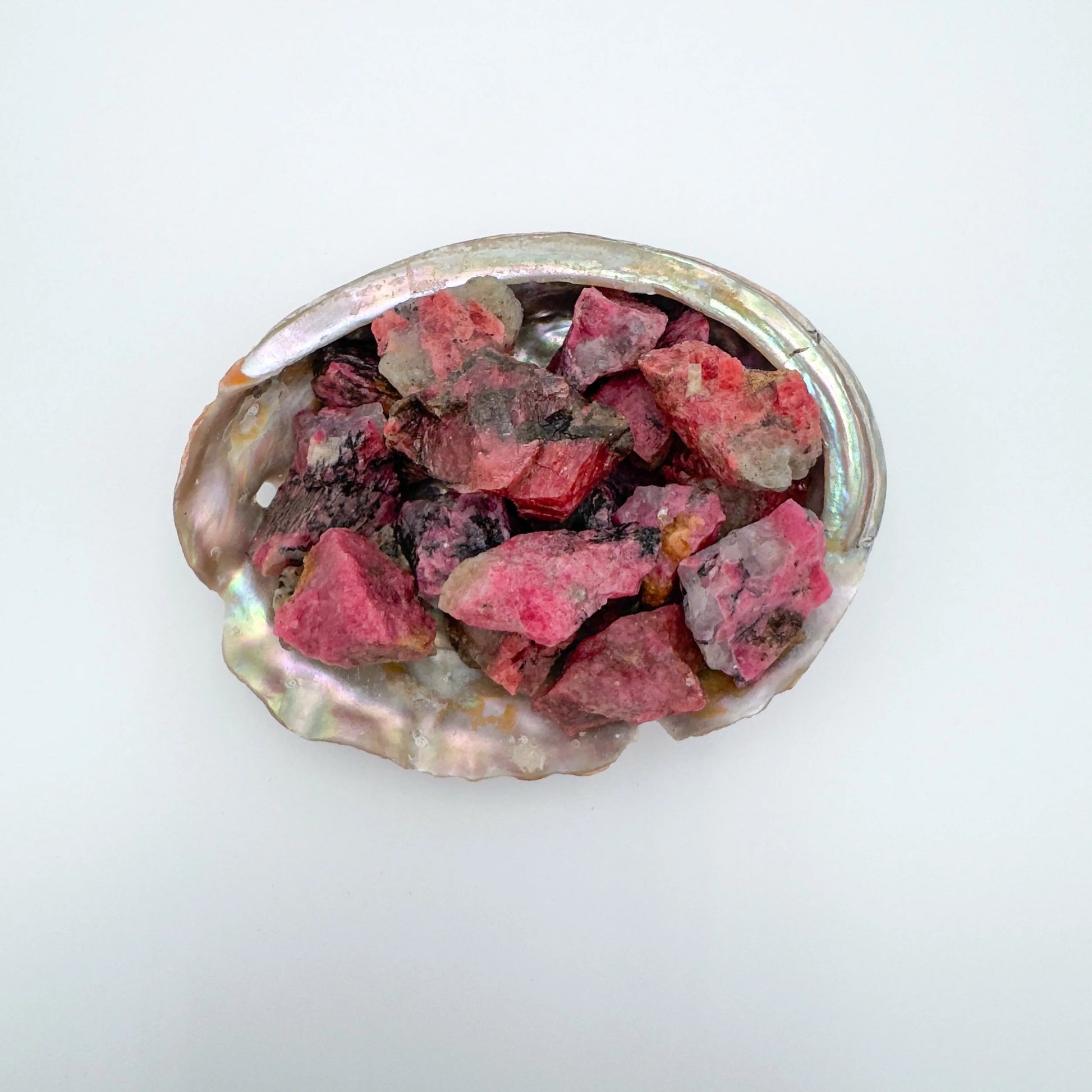 Detail shot showing Rhodonite raw stone, showing untreated character, traditionally used for Emotional Healing and Love.