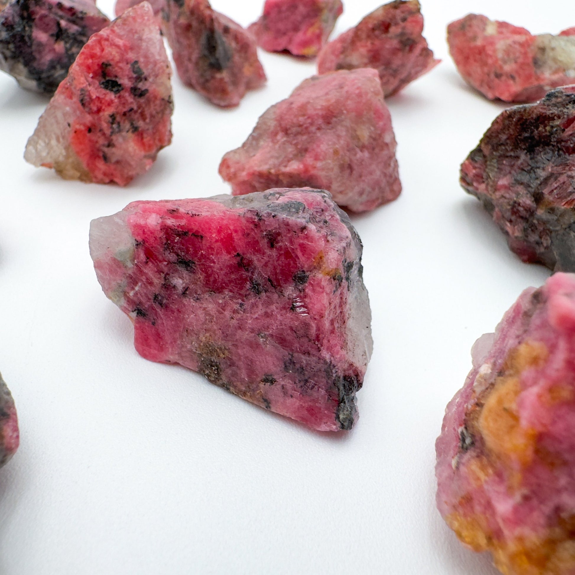 Overhead view of Rhodonite raw stone, showing honest grain.