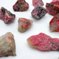 Back view of Grade AA Rhodonite raw stone, associated with Emotional Healing, sourced from Masvingo, Zimbabwe.