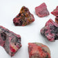Scale reference of a single Rhodonite raw stone Zimbabwe-sourced.