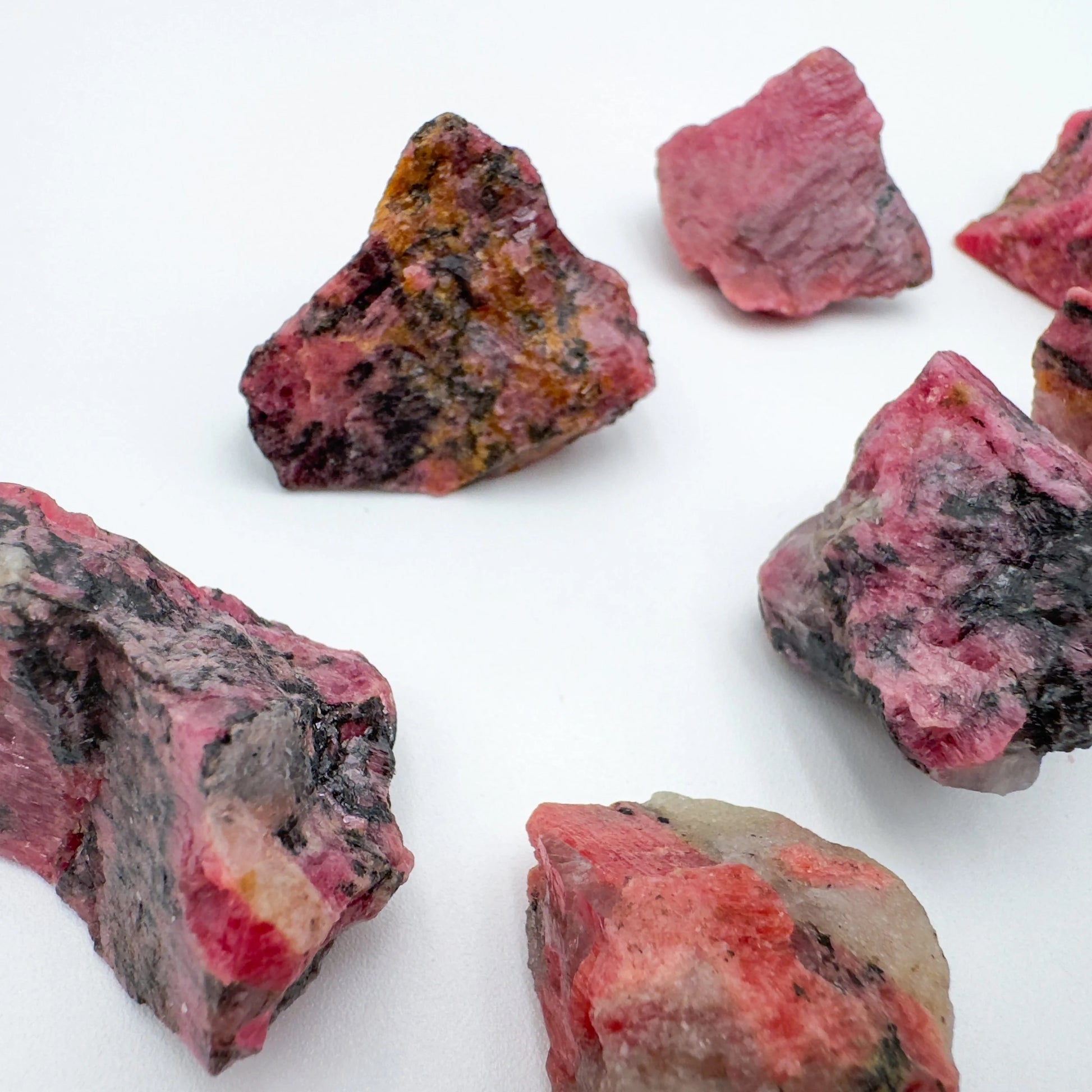 Scale reference of a single Rhodonite raw stone Zimbabwe-sourced.