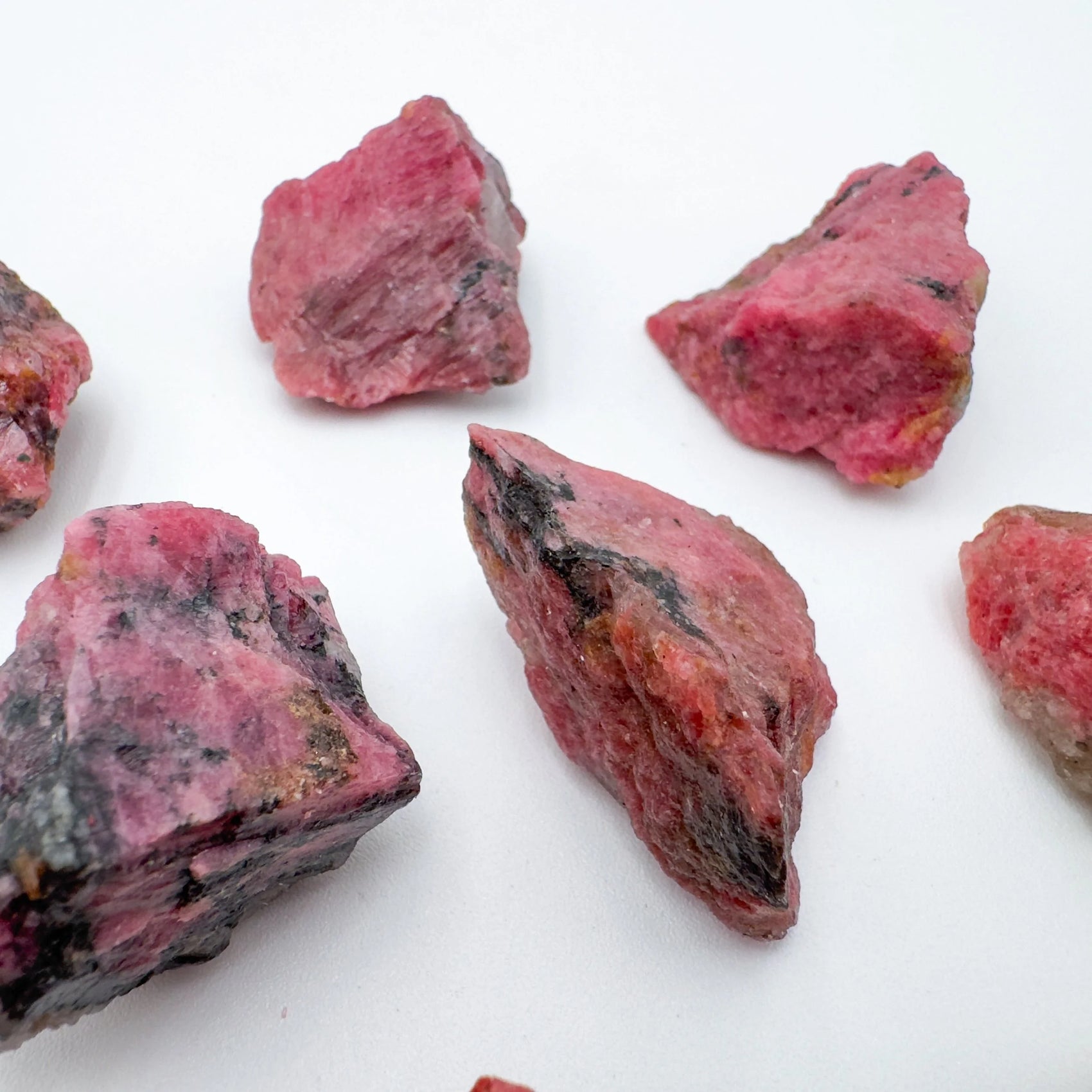 Close-up of Rhodonite raw stone from Zimbabwe, soothing wellness stone for Emotional Healing