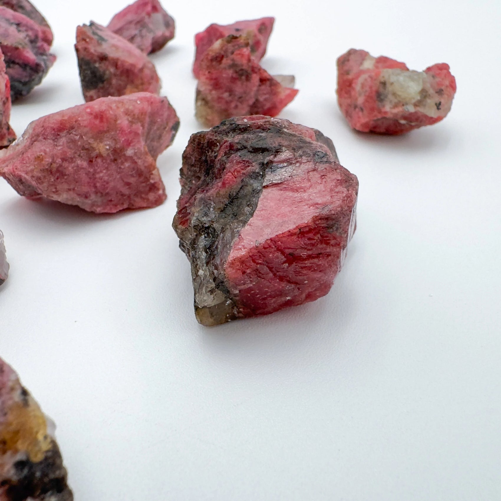 Rhodonite raw stone from Zimbabwe with Pink, Black color, polished finish for mindful calm