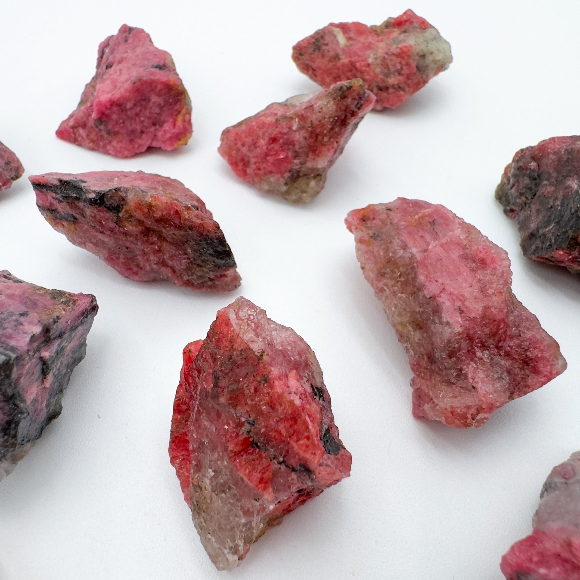 Detail shot of Grade AA Rhodonite raw under natural light