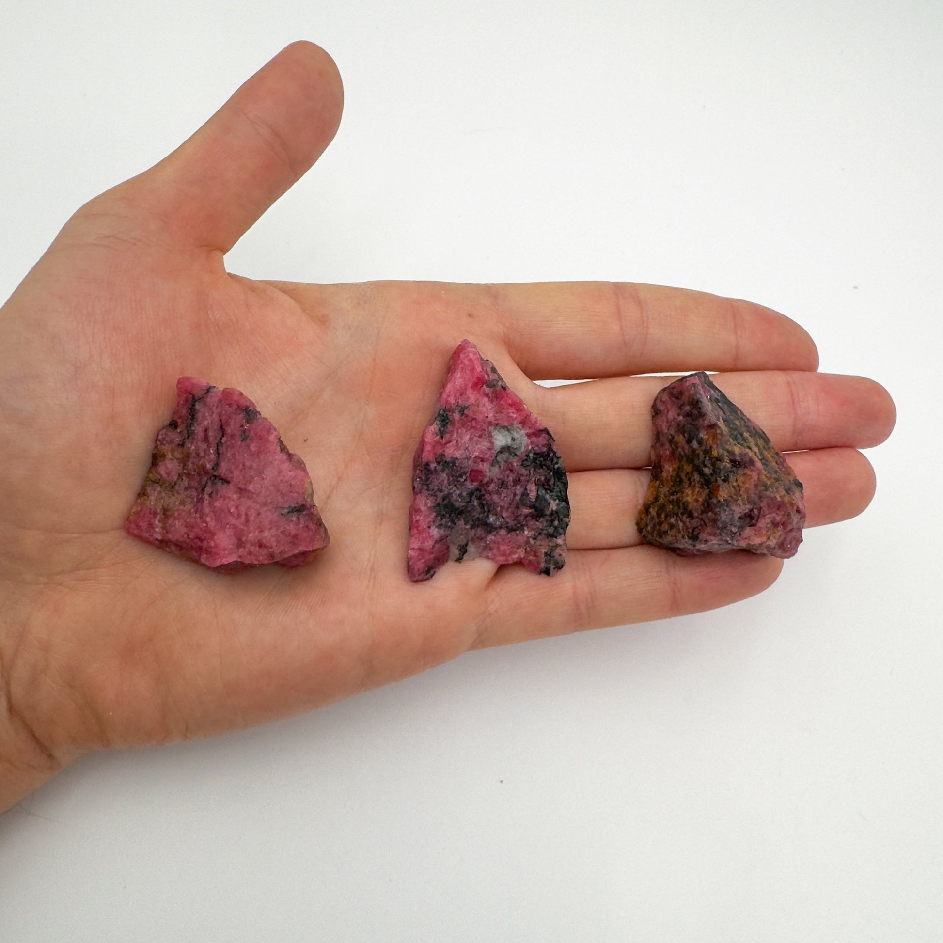 Full profile of Grade AA Rhodonite raw ready to ship from Beyond Bohemian