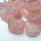 Top angle of Rose Quartz tumbled stone, showing glassy finish.