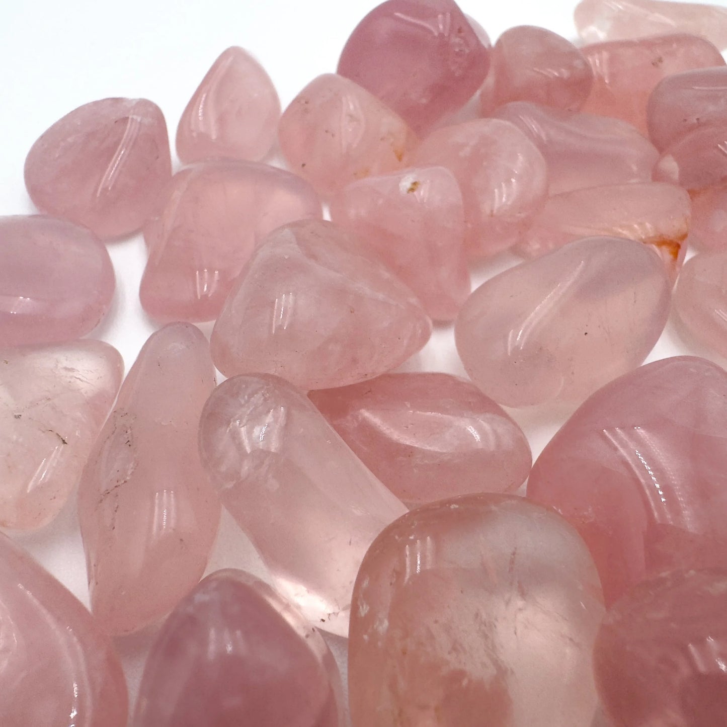 Back view of Rose Quartz tumbled stone, Brazil-sourced, showing natural texture.