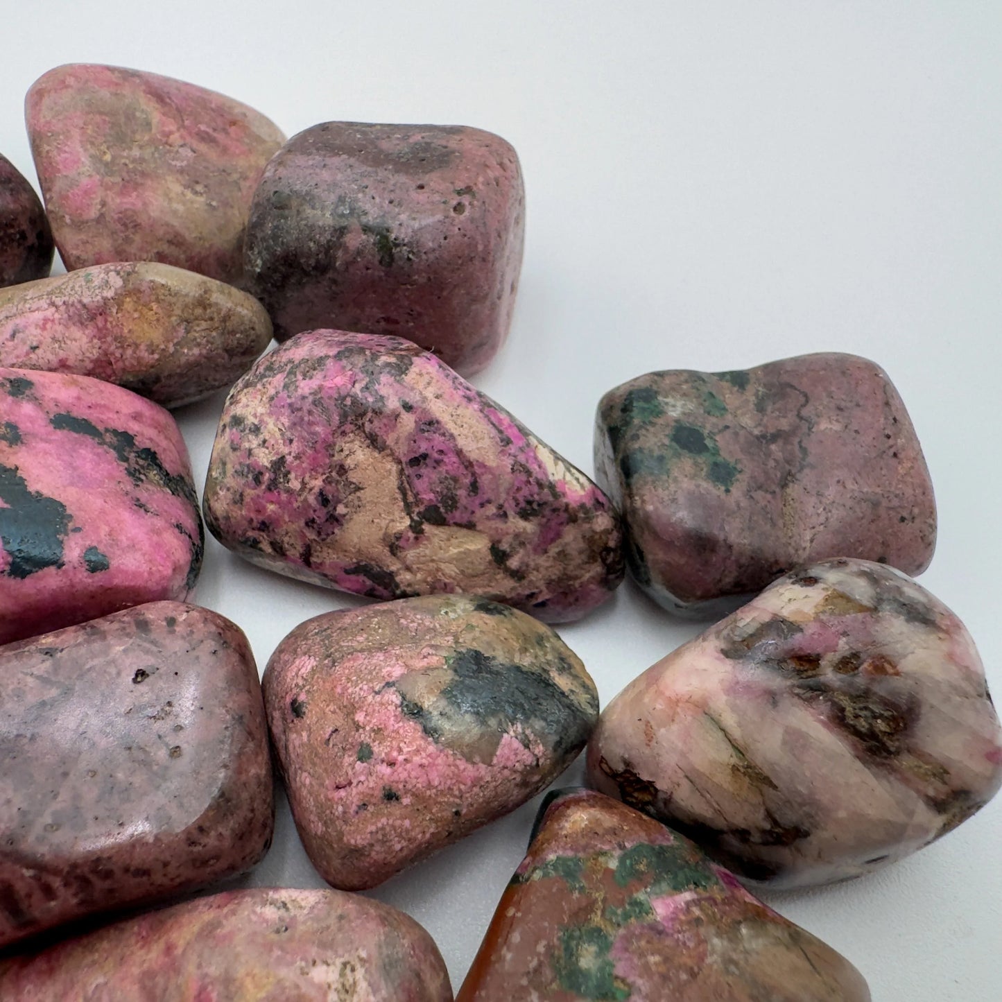 Underside view of pink Cobalt Calcite tumbled stone, sourced from Haut-Lomami, Democratic Republic of the Congo.