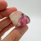 Back view of Grade A Cobalt Calcite tumbled stone showing natural surface