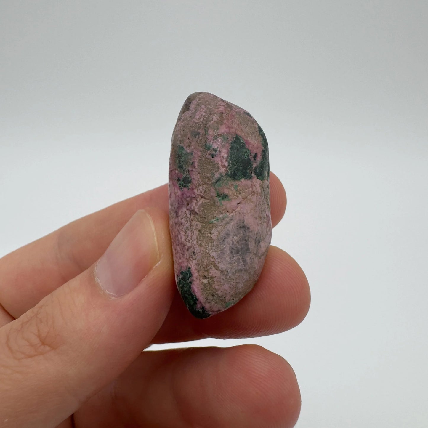Detail shot of Grade A Cobalt Calcite tumbled stone under natural light