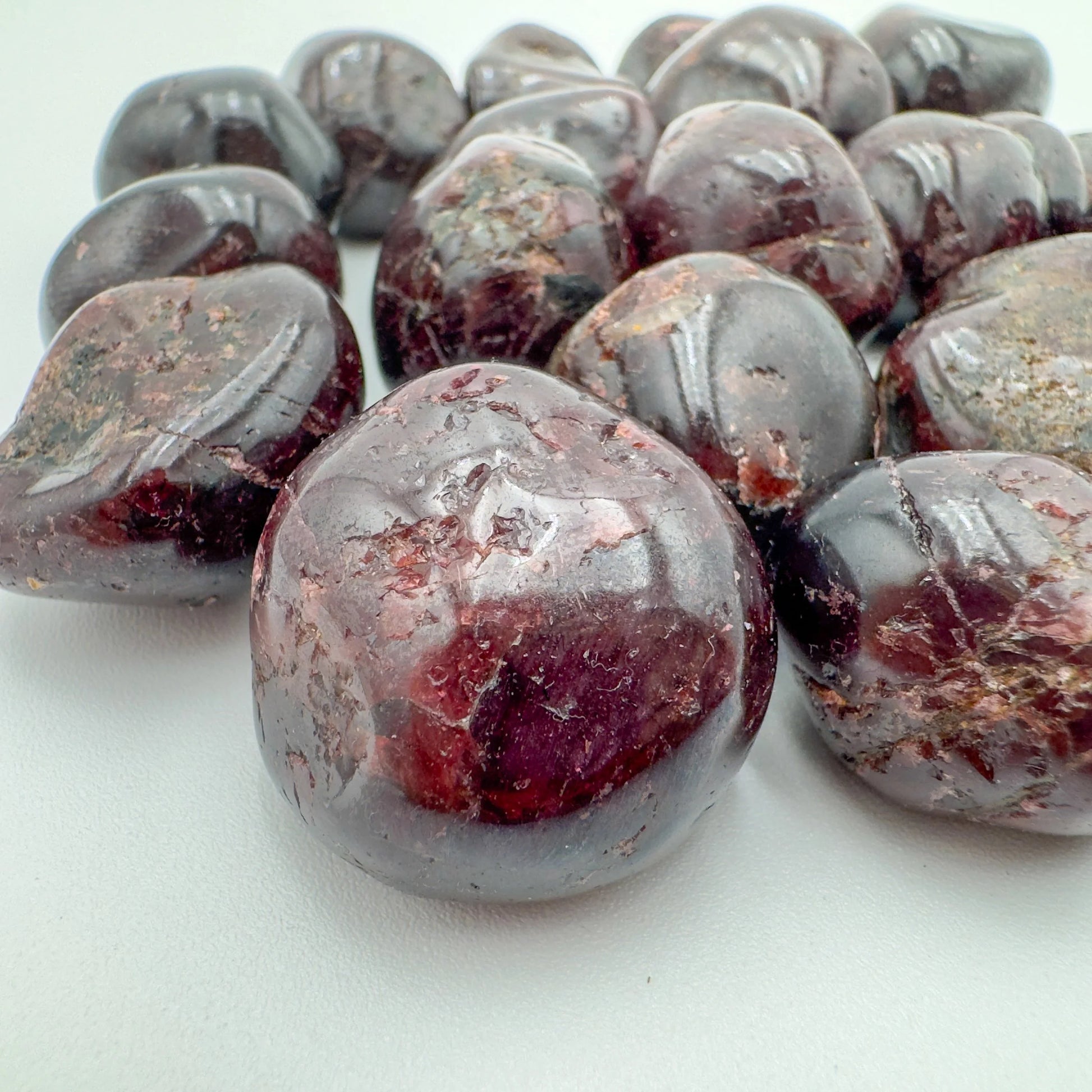 Near view of Garnet tumbled stone, sourced from Minas Gerais, Brazil, showing characteristic color.