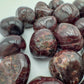 Looking down on Garnet tumbled stone, kept close for Energy, showing natural texture.