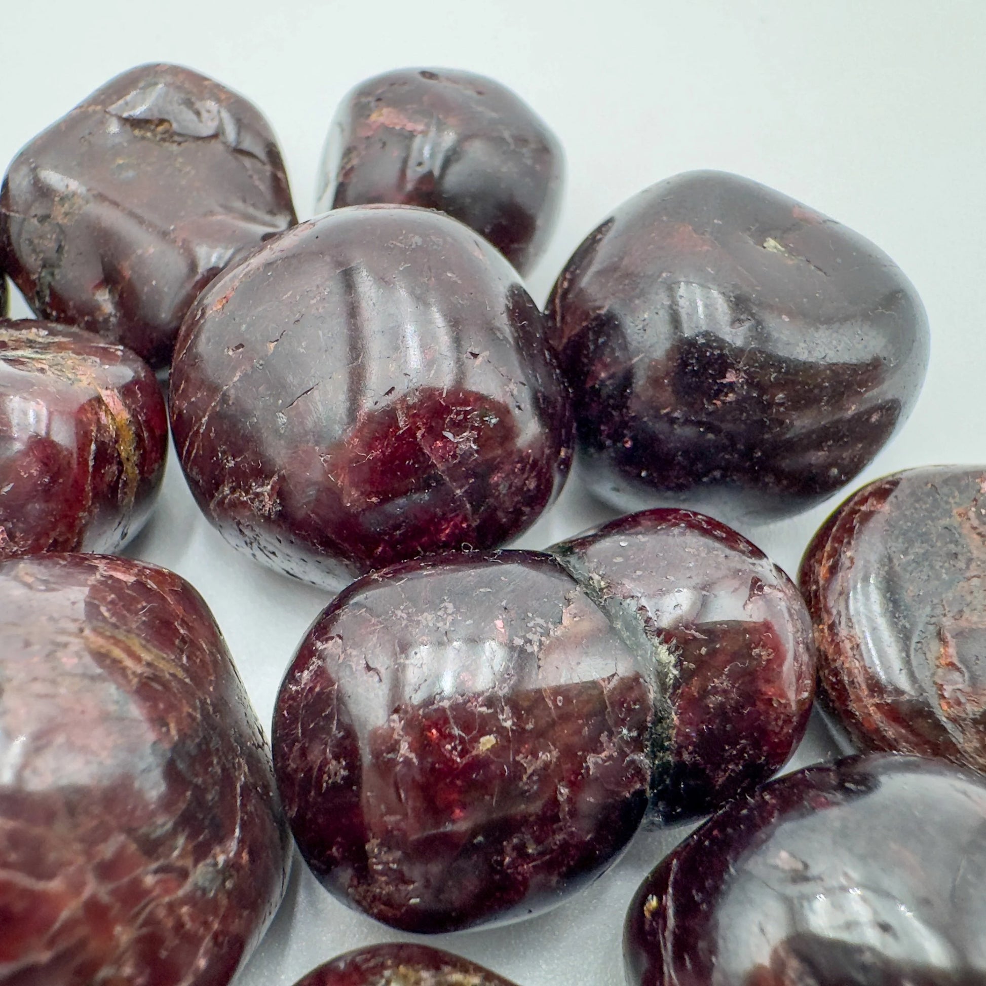 Rear view of Garnet tumbled stone, sourced from Minas Gerais, Brazil, for Energy and Confidence.