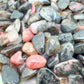 Detail capture of Rhodonite polished chip, showing soft luster.