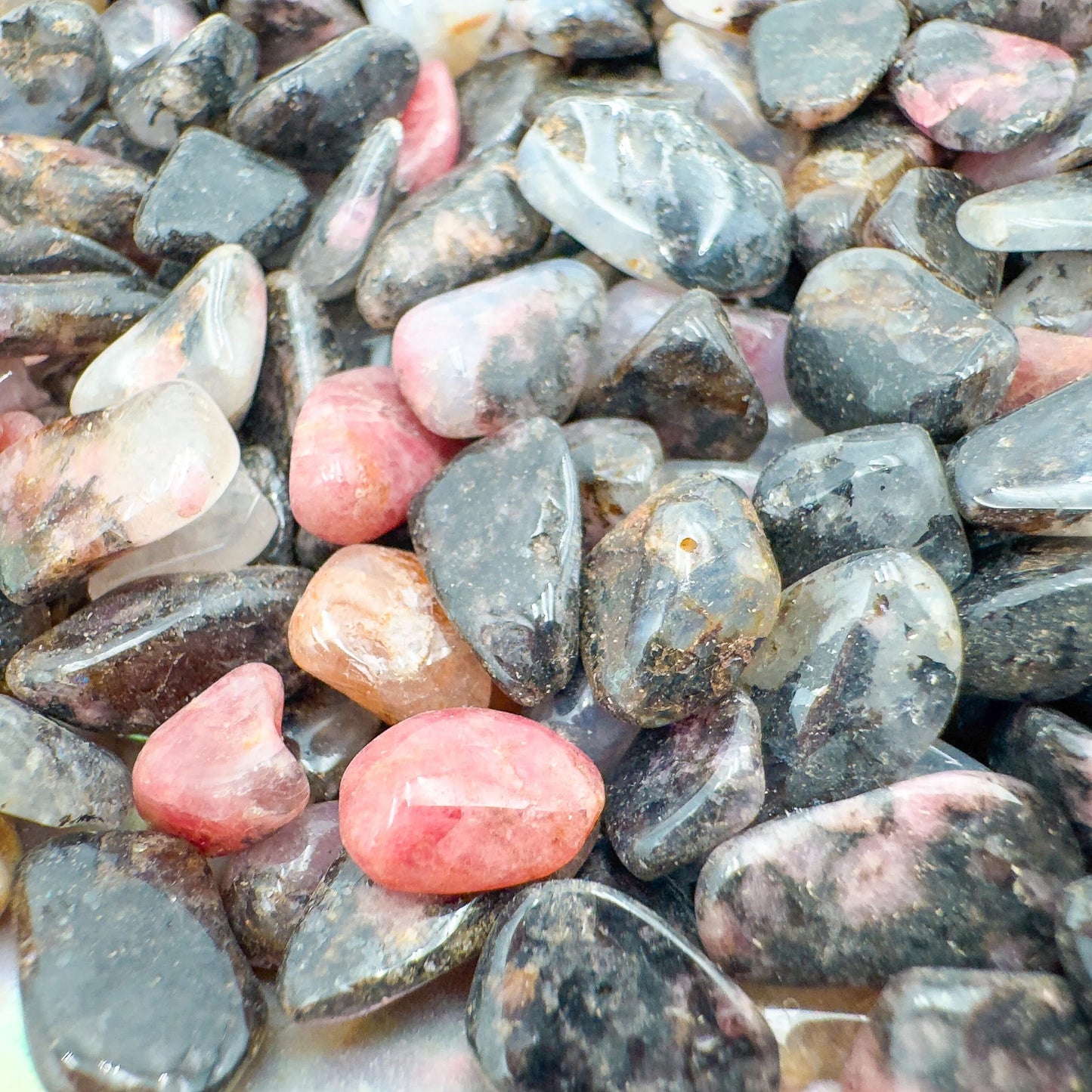 Detail capture of Rhodonite polished chip, showing soft luster.