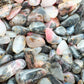 Plan view of Rhodonite polished chip, turned to for Emotional Healing and Love, hand-selected from Tete, Mozambique.