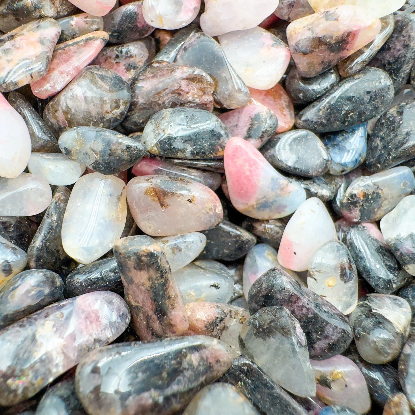 Plan view of Rhodonite polished chip, turned to for Emotional Healing and Love, hand-selected from Tete, Mozambique.