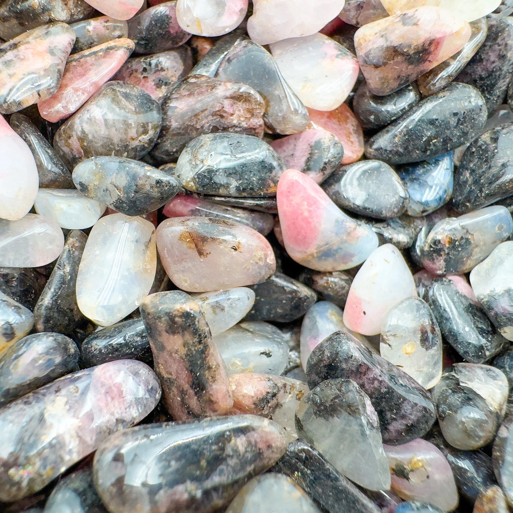 Plan view of Rhodonite polished chip, turned to for Emotional Healing and Love, hand-selected from Tete, Mozambique.