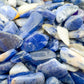 Side angle of Sodalite polished chip, showing glassy finish.