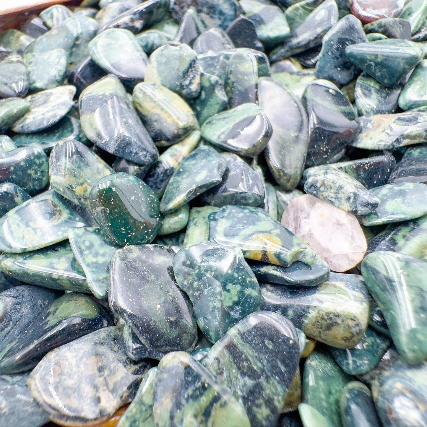 Detail of Kambaba Jasper polished chip, showing characteristic color, linked to Grounding and Stress Relief.