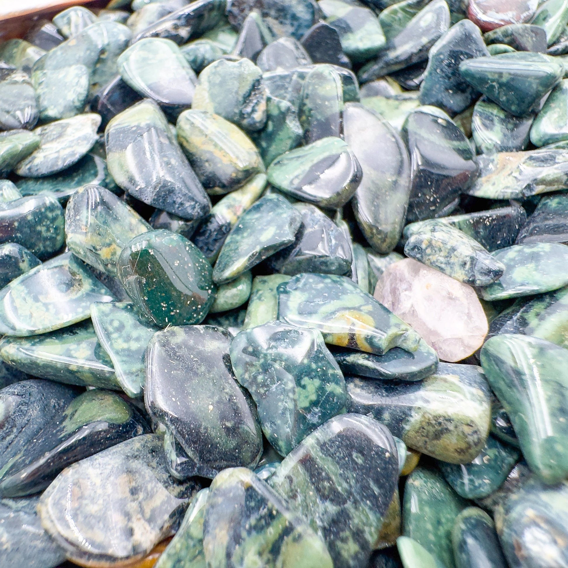 Detail of Kambaba Jasper polished chip, showing characteristic color, linked to Grounding and Stress Relief.