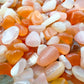 Color detail of Grade A orange Carnelian polished chip, traditionally used for Energy and Confidence, sourced from Francistown.