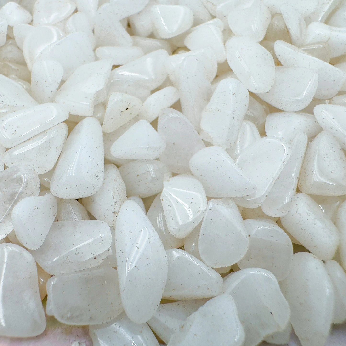 Up-close view of Grade A Snow Quartz polished chip, showing glassy finish.