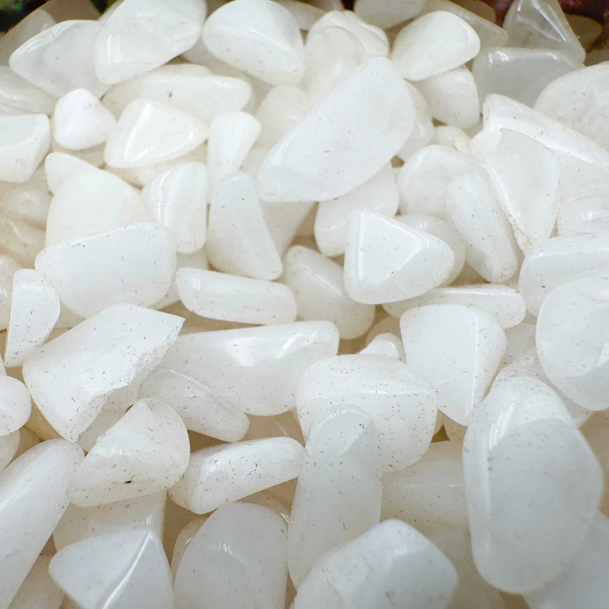 Side-on view of Grade A Snow Quartz polished chip, showing subtle veining, hand-selected from Zambezia Province, Mozambique.