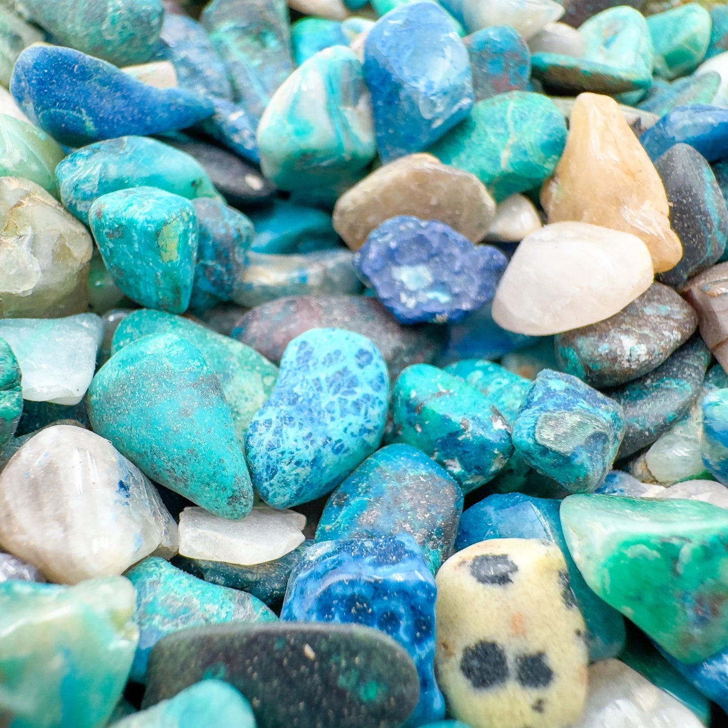 Detail capture of Grade A blue Chrysocolla polished chip, kept close for Emotional Healing.
