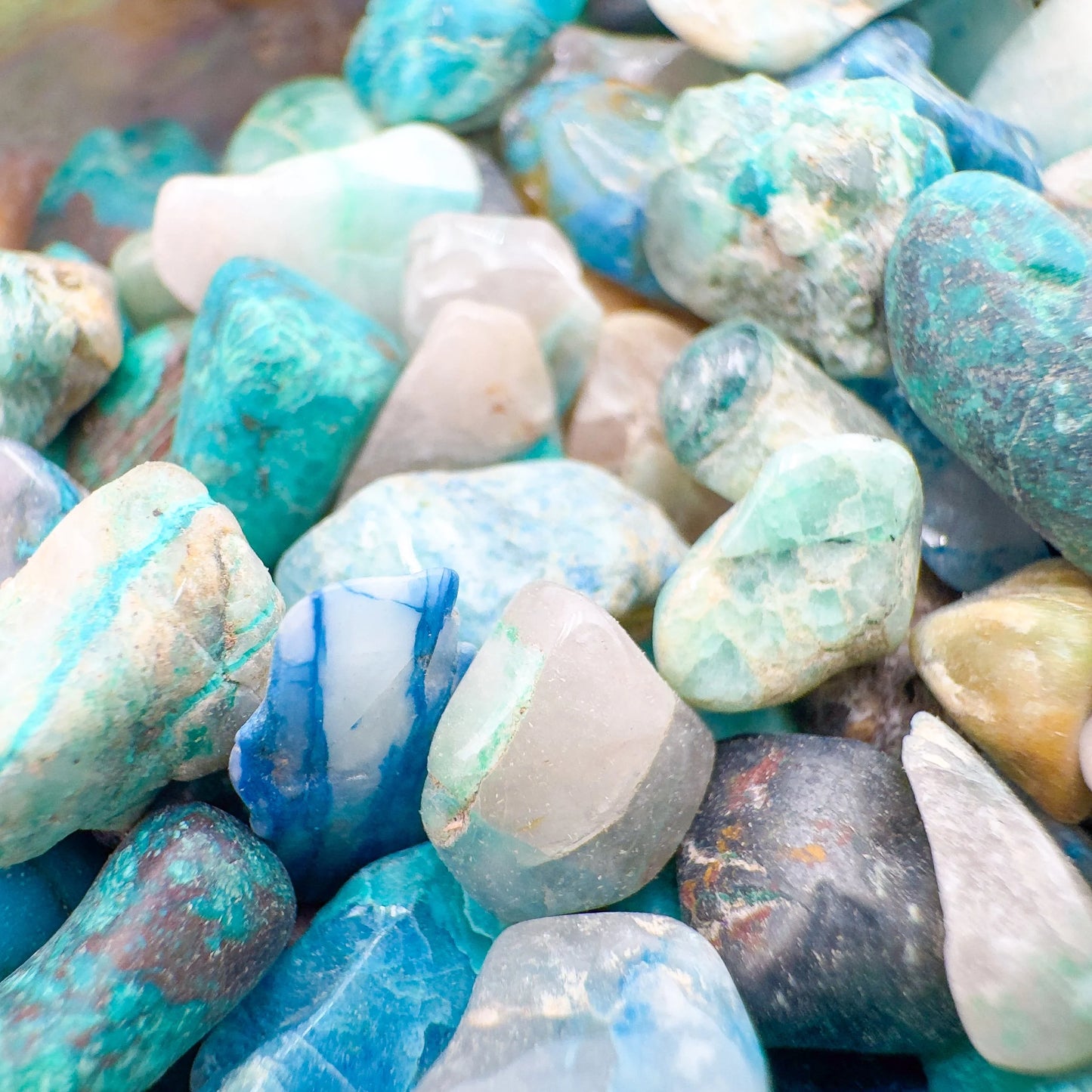 Top-side view of Chrysocolla polished chip, often worked with for Emotional Healing and Stress Relief, showing natural inclusions.