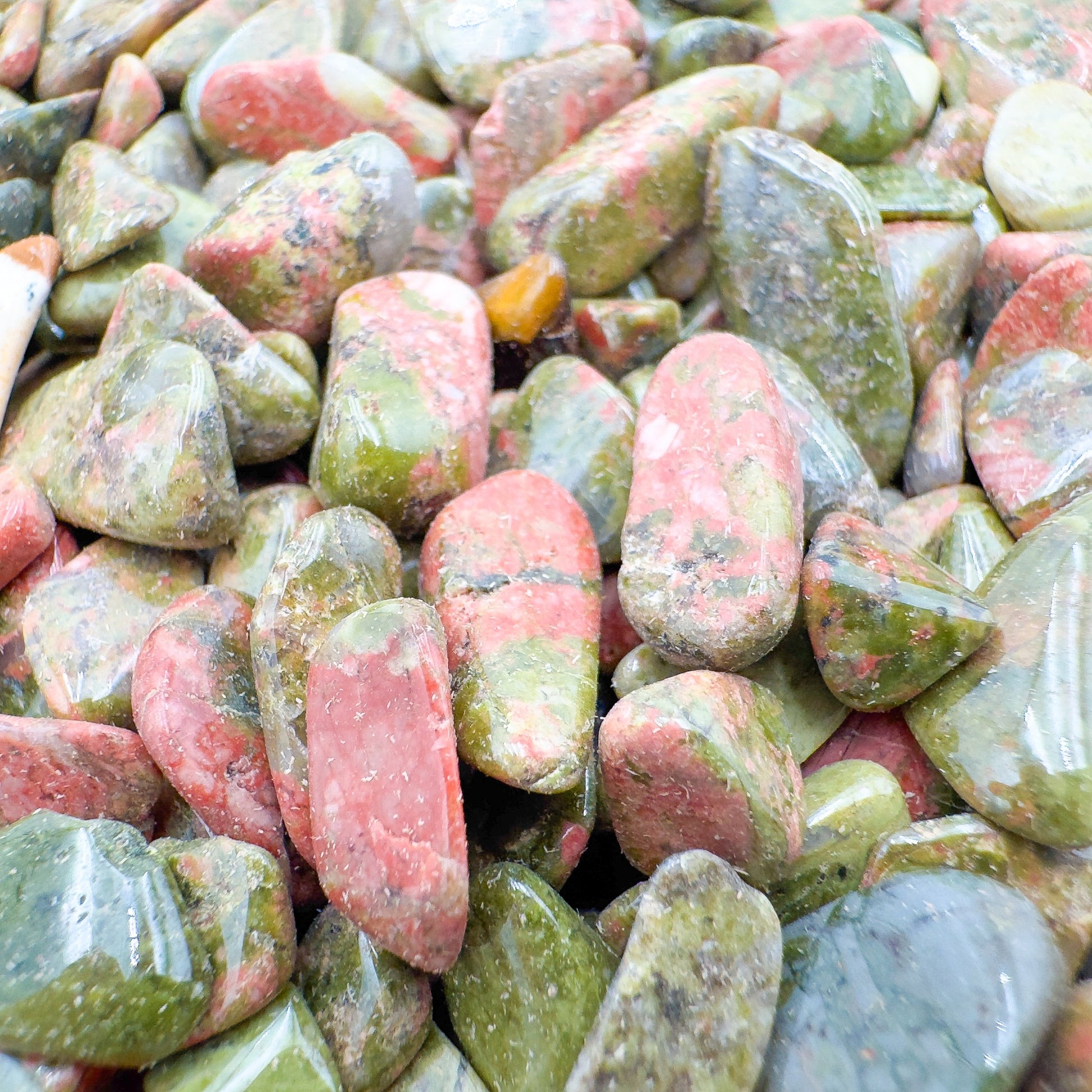 Macro view of Grade A green Unakite polished chip, sourced from Northern Cape, South Africa, showing characteristic finish.