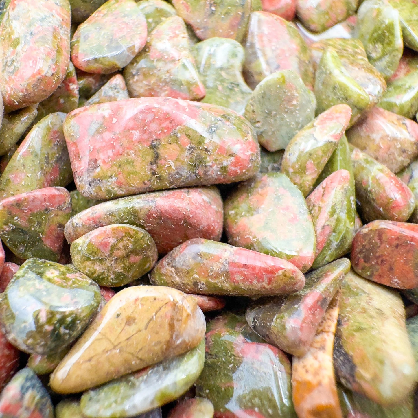 Side angle of Unakite polished chip, carried for Emotional Healing, showing natural inclusions.