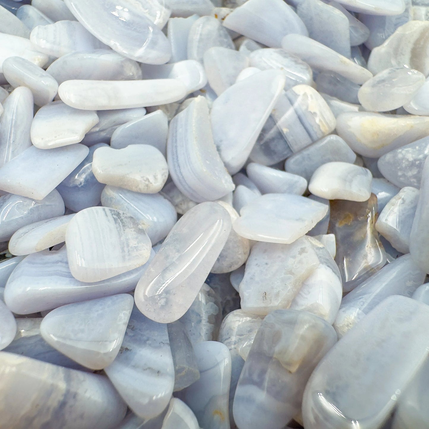 Top-down shot of Grade A Blue Lace Agate polished chip, often paired with practices around Stress Relief and Emotional Healing.