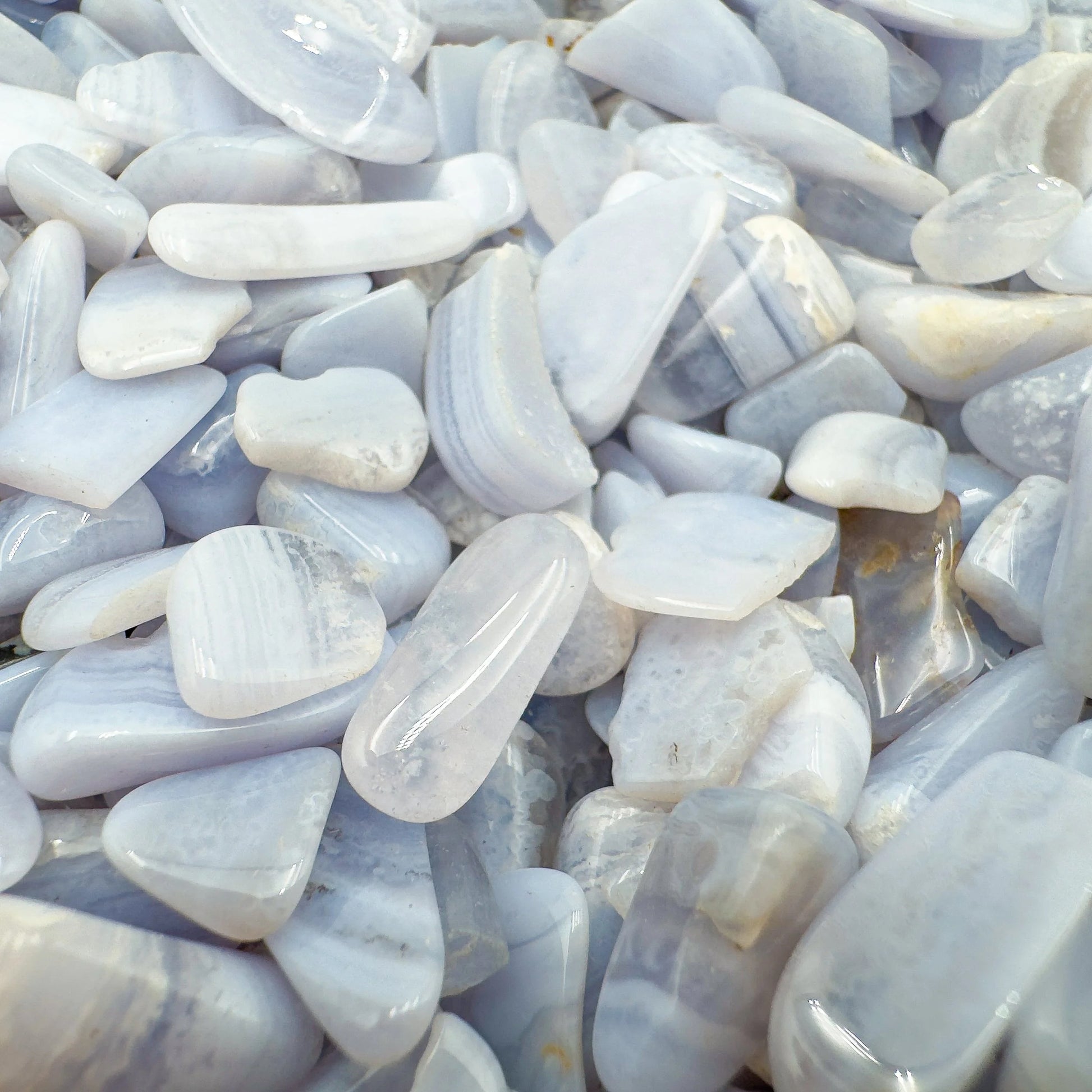 Top-down shot of Grade A Blue Lace Agate polished chip, often paired with practices around Stress Relief and Emotional Healing.