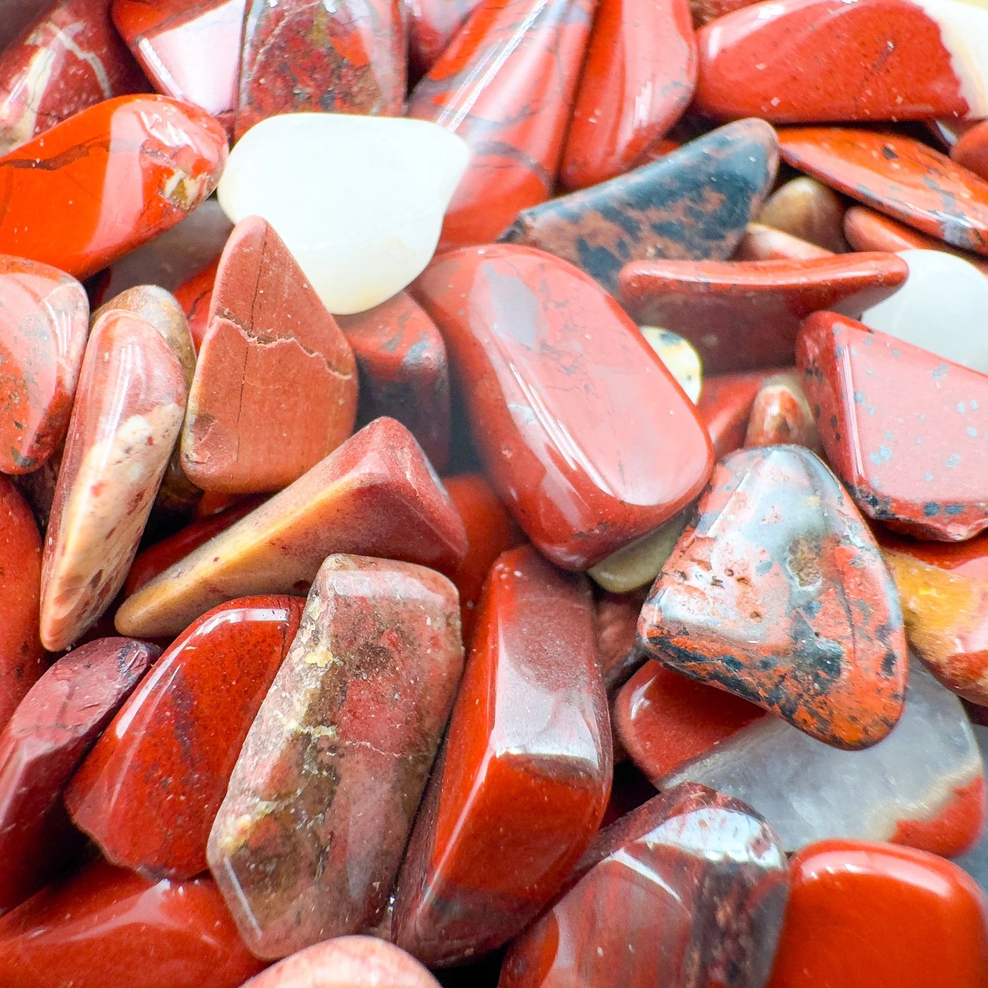 Aerial view of Red Jasper polished chip, often paired with practices around Grounding and Energy, sourced from South Africa.