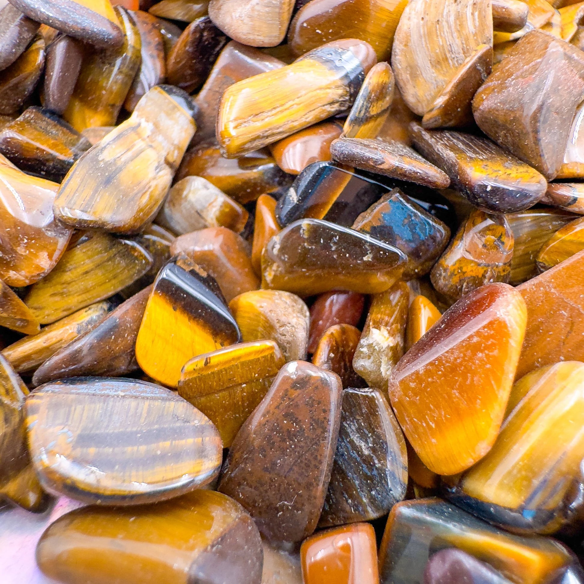 Close-up of Tiger Eye polished chip, turned to for Confidence and Career, showing natural sheen.