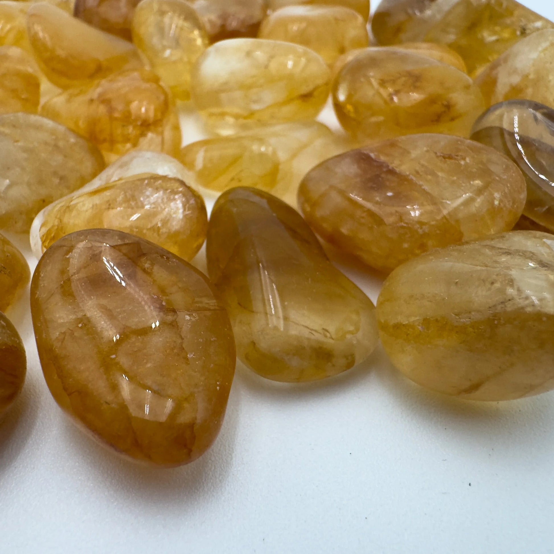 Aerial view of Grade AAA Golden Healer tumbled stone, often worked with for Healing, showing subtle veining.