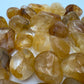 Profile view of Golden Healer tumbled stone, showing soft luster, for Healing and Meditation.