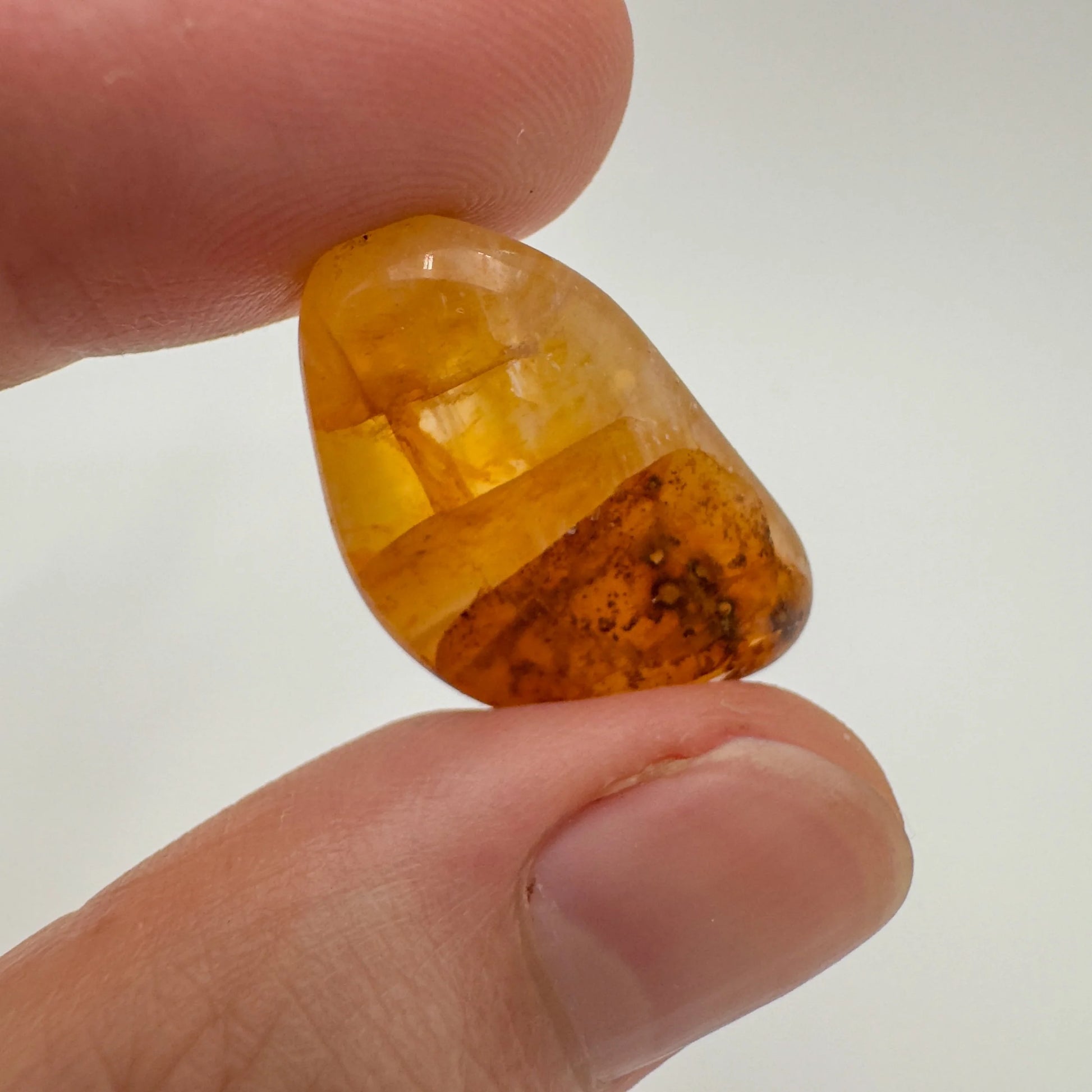 Lifestyle view of a Golden Healer tumbled stone linked to Healing and Meditation, sourced from Minas Gerais, Brazil.