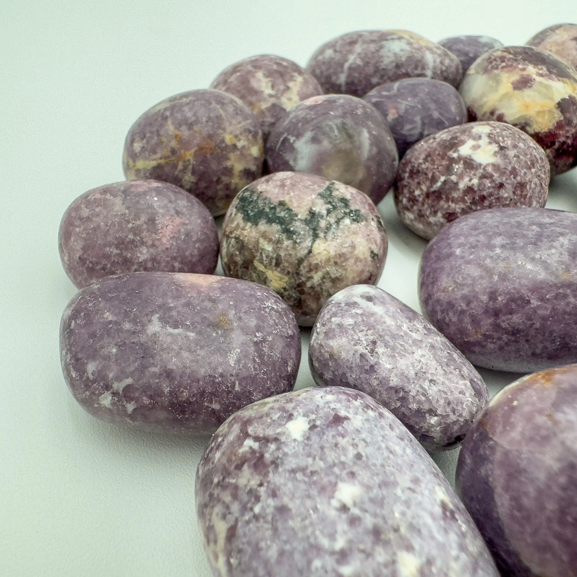 Side angle of Lepidolite tumbled stone, often kept for Stress Relief and Emotional Healing.