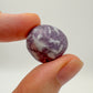 Scale reference of a single Lepidolite tumbled stone hand-selected from Arequipa, Peru.