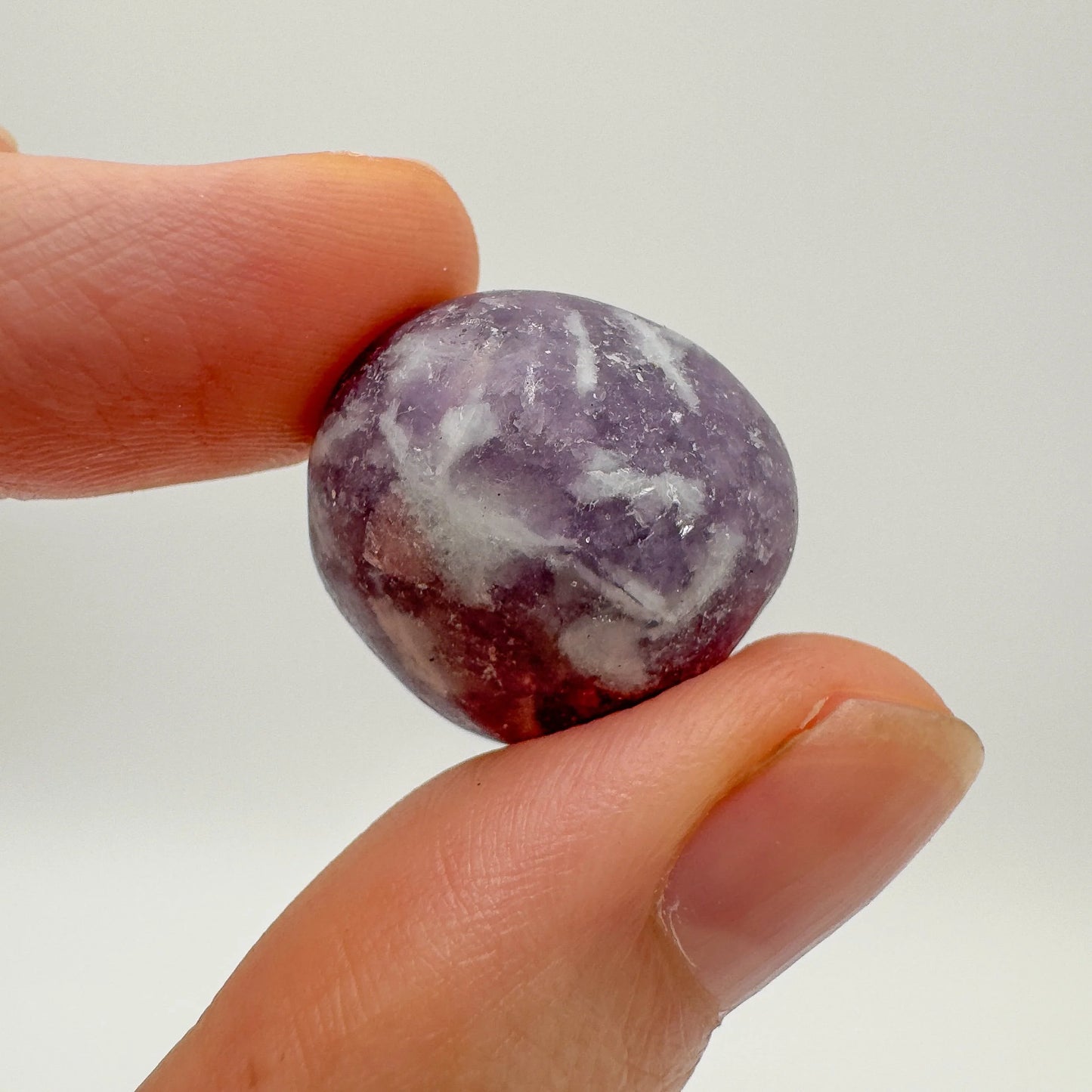 Scale reference of a single Lepidolite tumbled stone hand-selected from Arequipa, Peru.