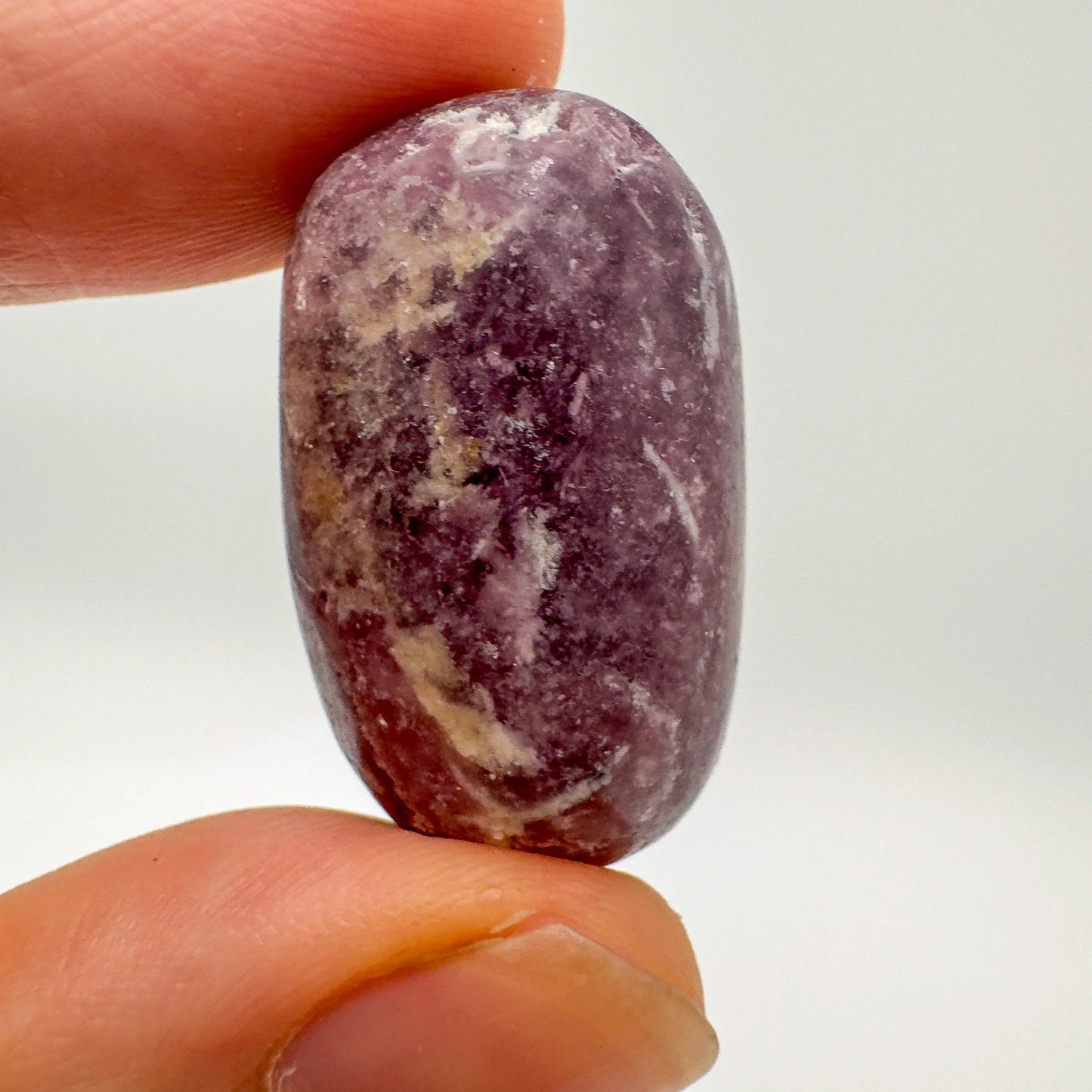 Companion image of Lepidolite tumbled stone, from Arequipa, Peru, with form visible in context.