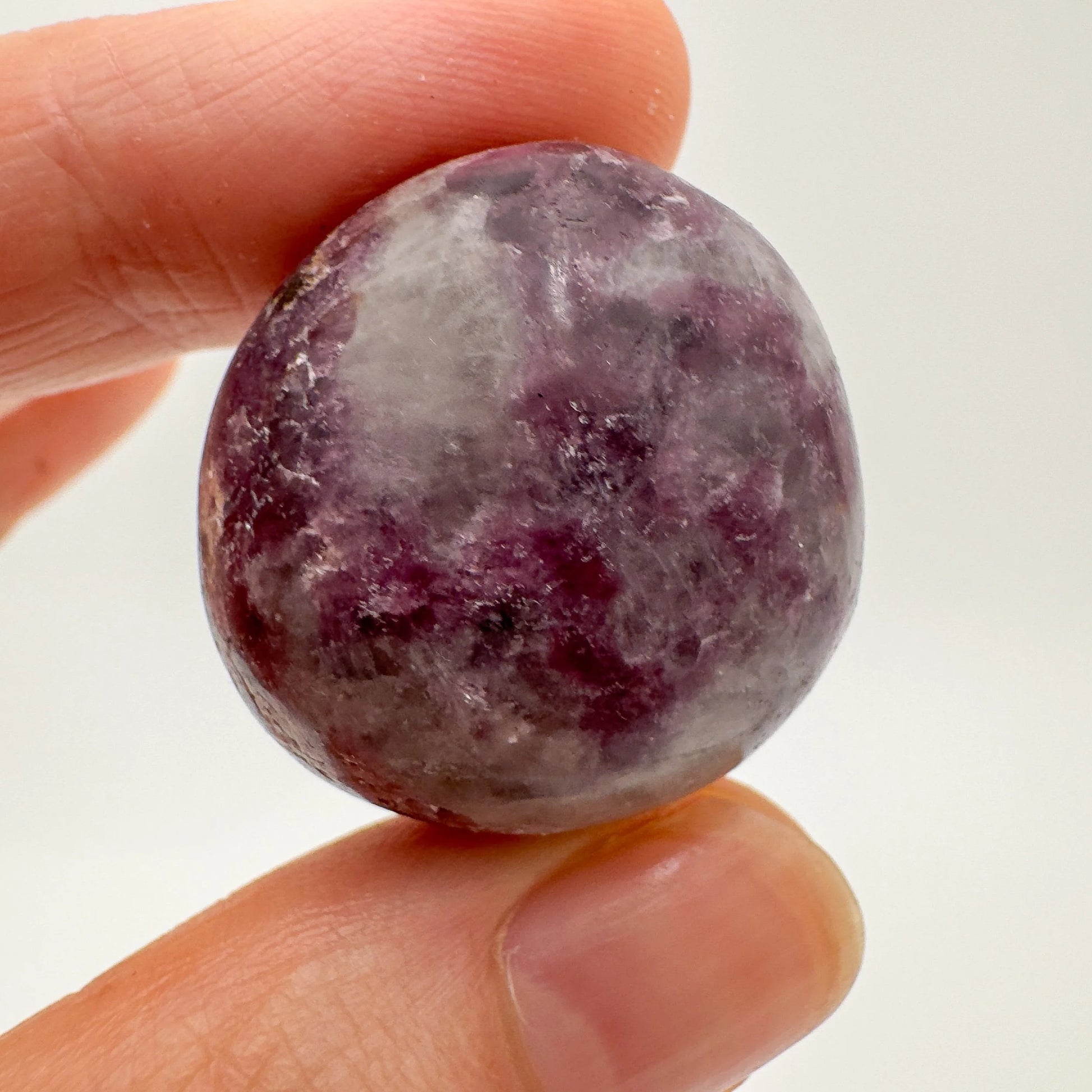 Back view of Grade AA Lepidolite tumbled stone showing natural surface